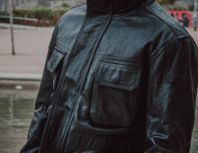 Front pocket detail of the Black Leather Jacket Coat, showcasing its functional design.