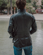 Front closure detail of the Black Leather Jacket Coat, featuring durable hardware for lasting wear