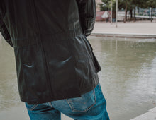 Side view highlighting the tailored fit and modern design of the Black Leather Jacket Coat.