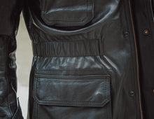 Close-up shot showcasing the luxurious texture of the premium black leather used in the Men's Jacket Coat