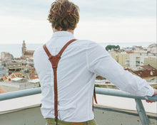 brown leather suspenders with a white shirt, showcasing the fine leather texture