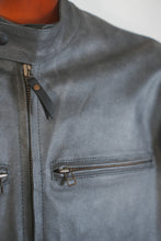 Close-up of snap-tab collar and front zippers on café racer jacket