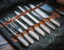 Professional chef knives in handcrafted leather and waxed canvas knife roll, close-up of storage slots and blades
