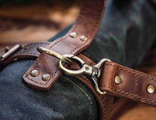 Close-up of brass clasp and leather strap fastening on rolled chef knife bag