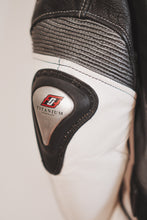 Close-up titanium shoulder protector on racing leather jacket