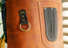 Close-up of a handmade leather waist apron, showcasing its unique stitching and black leather pocket. Perfect for chefs, baristas, or bartenders looking for a professional apron