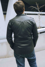 Casual men’s leather shirt jacket, model looking down