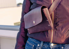 Handmade leather crossbody bag in burgundy, featuring a detachable strap, elegant rivet details, and a matching cardholder for secure storage.