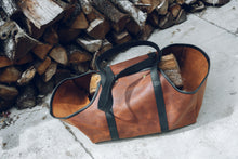 Description: This image depicts a meticulously crafted handmade leather log carrier, intricately designed for the purpose of transporting firewood. It presents a practical and stylish solution, prioritizing durability to facilitate effortless log transportation.