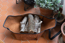 Description: This image showcases a meticulously crafted handmade leather log carrier, specifically designed for transporting firewood. It offers a practical and stylish solution, emphasizing durability to ensure effortless log transportation.