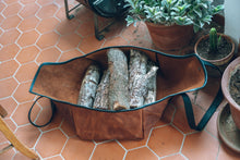 Image of a handcrafted leather log carrier, exemplifying durable construction and stylish craftsmanship, perfect for transporting firewood.