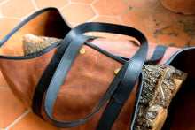 Handcrafted leather log carrier displaying durable construction and stylish craftsmanship, designed for ideal firewood transportation.