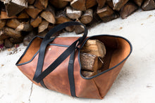 This image depicts a handcrafted leather log carrier, showcasing sturdy construction and elegant craftsmanship. It is designed specifically for transporting firewood, providing an ideal solution for carrying logs with durability and style.