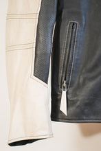 Detailed view of white leather sleeve with black perforated leather insert and zipper