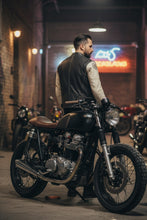 Back view of man in black and white motorcycle leather jacket with café racer patches