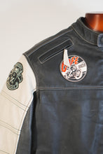 Close-up of round Café Racer motorcycle patch on black leather jacket