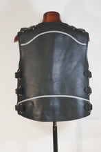 Back of handmade black leather vest with reflective stripe