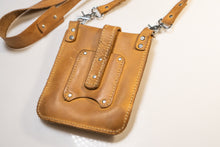 Front view of genuine yellow leather crossbody bag with metal hardware and stitching details