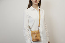 Woman in white shirt wearing minimalist yellow leather crossbody bag for women by FashionRacing custom leather
