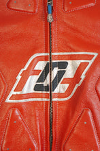 Close-up of red leather motorcycle jacket logo detail