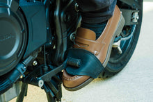 Black leather motorcycle gear shift protector covering brown loafer during motorcycle ride – Fashion Racing