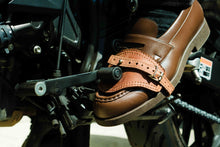 Motorcycle shoe protector engaged with gear pedal – practical leather accessory for daily riders