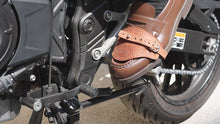 video - Motorcycle shoe protector engaged with gear pedal – practical leather accessory for daily riders