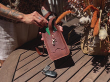 Video showcasing the features and design of a handmade leather phone crossbody bag, including its various pockets and strap, with close-up shots and different angles.