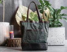 Minimalist waxed canvas tote bag with soft leather handles, durable and water-resistant everyday carryall for women. Stylish handcrafted tote ideal for work, travel, or casual wear.