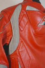 Detailed view of red and gray leather panels on the back shoulder of the motorcycle jacket