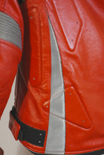 Side view of red and silver motorcycle jacket showing padded panels and reflective strips