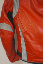 Red motorcycle racing jacket with gray stretch panels and protective padding on the back