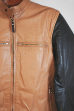 Close-up of side pocket zipper on tan leather motorcycle jacket