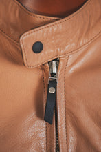 Collar and zipper detail of tan and black leather biker jacket