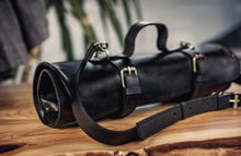 Close-up of full-grain black leather and brass hardware