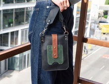Small vertical bag for women. Black, brown, green leather. Wide strap.