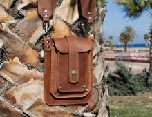 Brown leather phone bag with wide crossbody strap