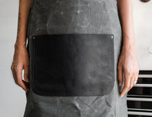 large black leather pockets of apron