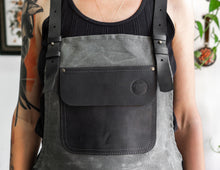 grey canvas apron with black leather pocket
