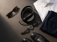 Black full-grain leather belt with minimalist buckle for refined everyday styling.