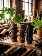 Handcrafted Motorcycle Tool Roll crafted from premium genuine leather, shown in brown, tan, and black color options on a rustic workshop table. Durable roll-up leather tool organizer with adjustable buckle straps and ergonomic carry handle, designed to securely store motorcycle tools, EDC gear, and repair essentials. Compact leather motorcycle tool roll for bikers, mechanics, café racer, scrambler, and vintage motorcycle enthusiasts. Stylish workshop display highlighting multiple leather finishes and artisa