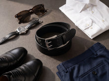 Black full-grain leather belt with silver buckle for polished smart-casual outfits.
