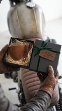 gift box containing Close-up of brown leather motorcycle shifter boot protector and keichain