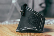 Black leather motorcycle shifter protector with white stitching for shoe protection.
