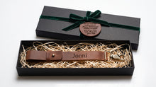 Personalized Brown Leather Glove Strap Holder engraved with the name and presented in a premium black gift box with decorative ribbon and custom leather anniversary tag. Handmade genuine leather glove holder featuring a secure belt loop, adjustable strap, and swivel snap hook. A thoughtful personalized gift for motorcycle riders, bikers, husbands, anniversaries, birthdays, Father's Day, Christmas, and everyday carry (EDC) enthusiasts.