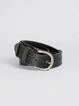 Black croc embossed leather belt on a neutral background