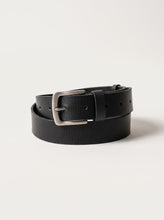 A black textured leather belt with a silver-tone metal buckle, neatly coiled on a light off-white background.