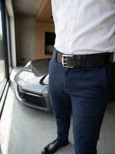 Black full-grain leather belt with double-prong silver buckle for tailored everyday wear.
