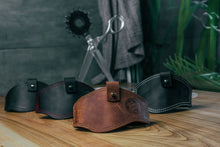 Brown and black leather motorcycle shifter protector designed to shield footwear from gear-shift scuffs.
