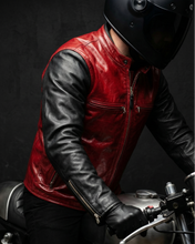 Men wearing a red and black leather jacket and helmet on a motorcycle.
